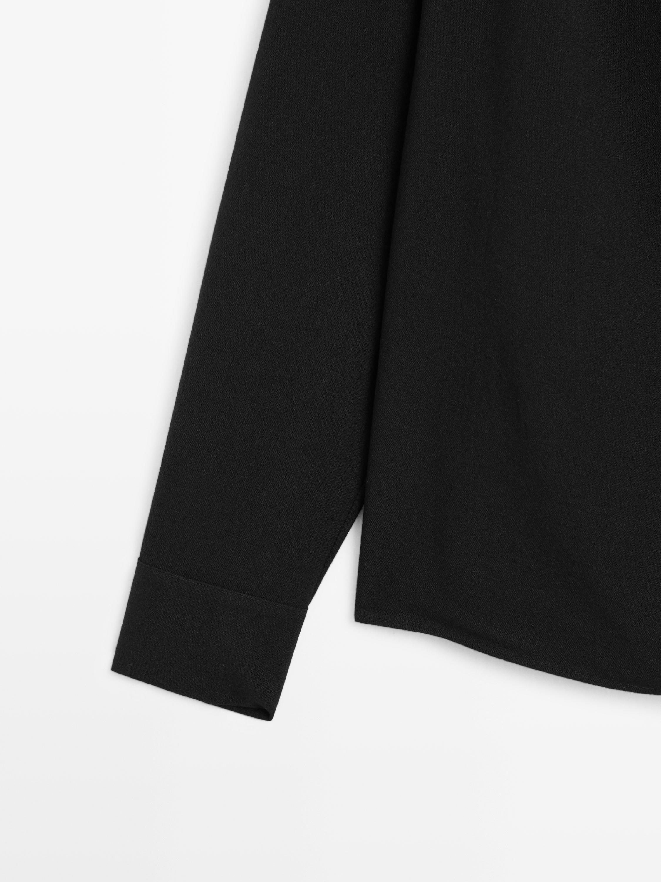 Blouse with crossover detail and button